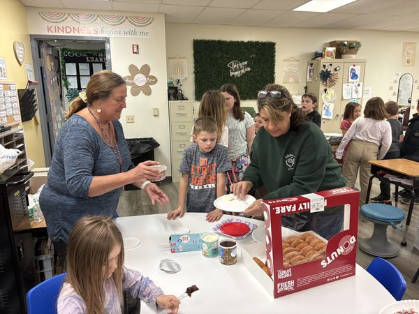 Theresa and children enjoying a donut-themed family activity